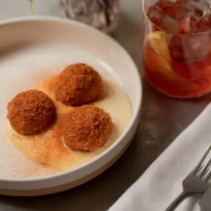 Small plate of Arancini and negroni