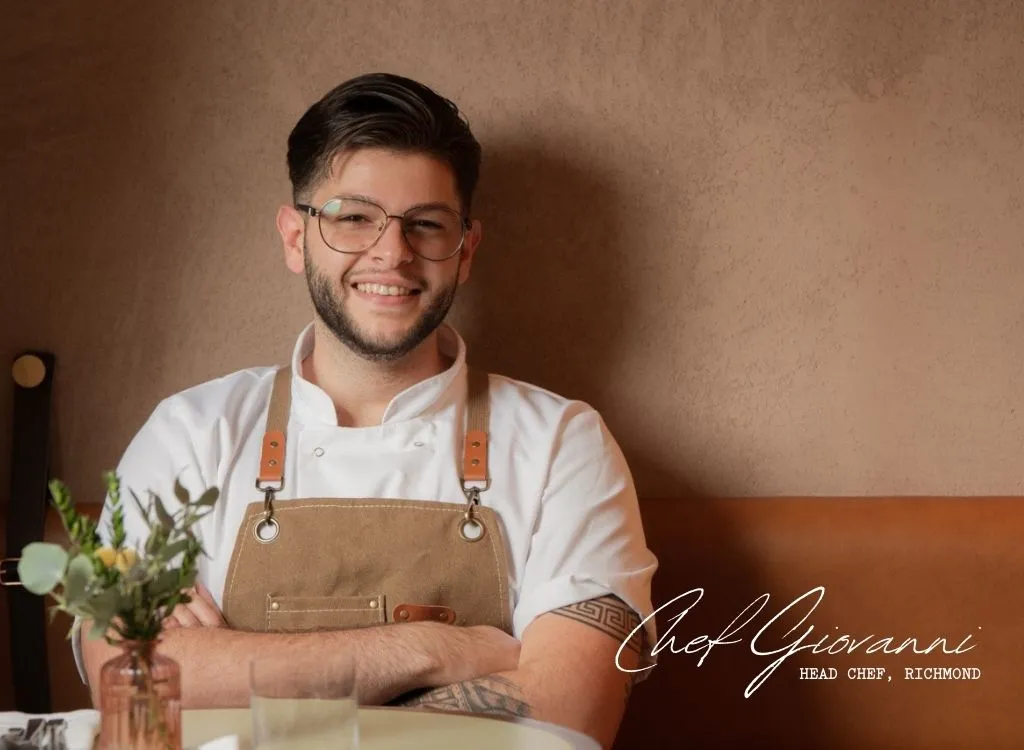 chef, sitting with his arms crossed smiling