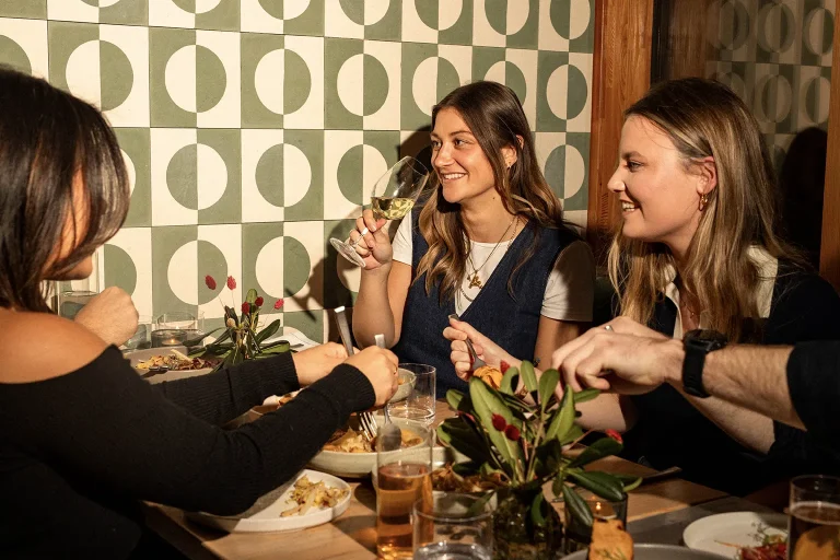 Group of friends eating and drinking in Noci