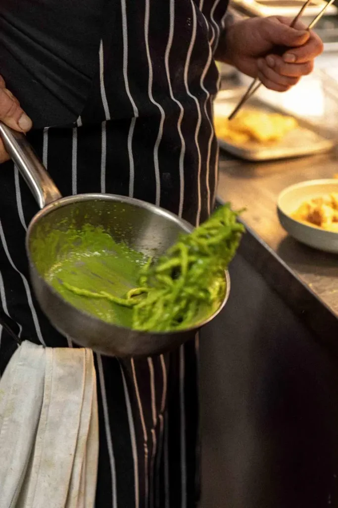 A chef preparing fresh pasta in the kitchen