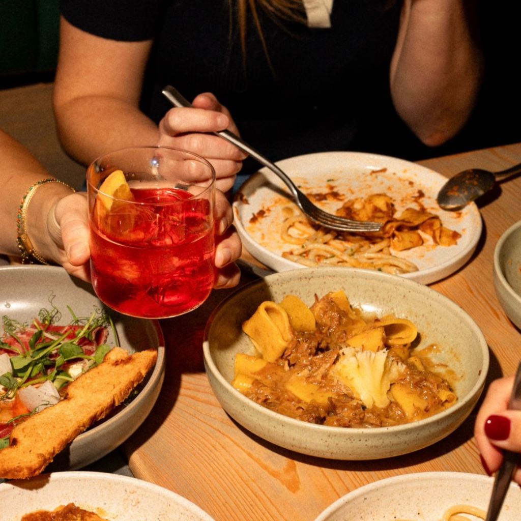 Ladies enjoying noci pasta and spritz